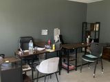 a room with a desk, chair, and bookshelf in it