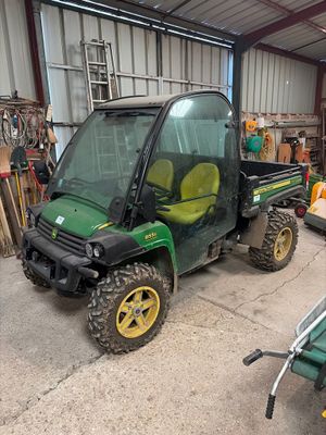 a small green utility vehicle parked in a garage