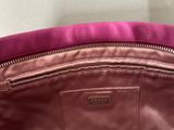 the inside of a purple purse with a zipper on it