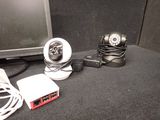 two webcams sitting next to each other on a desk