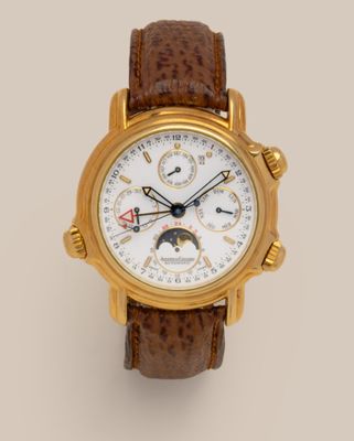 a close up of a gold wrist watch with a brown leather strap