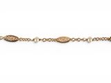 a close up of a gold chain bracelet with pearls on it