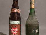 two bottles of alcohol sitting next to each other on a table