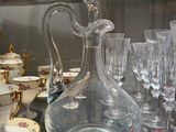 many glasses and a decanter sitting on a table