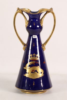 a blue and gold vase with a crown on it