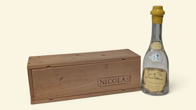 une image représentant une bouteille d'alcool à côté d'une caisse en bois