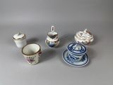 a small collection of porcelain objects sitting on a table