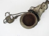 a metal object with a chain around it on a white surface