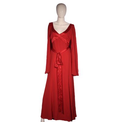 the dress is red and has long sleeves and a belt