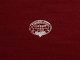 the back of a red shirt with a white logo on it