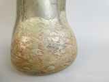 a silver vase with a gold leaf design on it