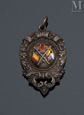 a close up of a silver medal with a cross and two flags on it