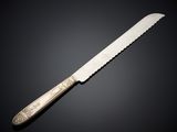 a knife with a silver handle on a black background