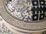 a blue and white vase with a lid on a table