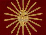 an image of a gold heart on a red velvet background