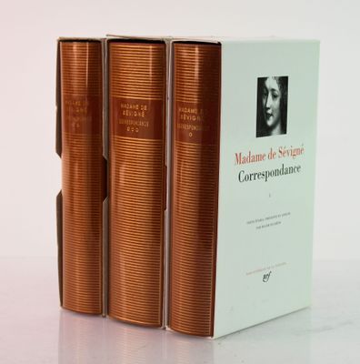 three books sitting on top of a white table next to each other