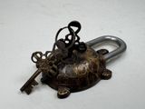a key on top of a turtle shaped key holder