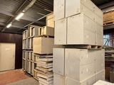 many stacks of boxes stacked on top of each other in a warehouse