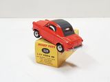 a red toy car sitting on top of a yellow box