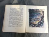 an open book with a picture of a person sitting on a bench