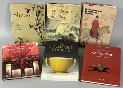 several books are stacked on top of each other on a table