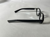 a pair of black glasses on a white surface