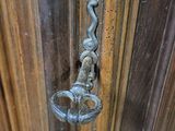 a close up of a door handle on a wooden door