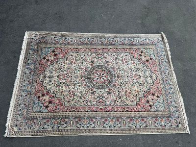 a rug on the ground with a flower design on it