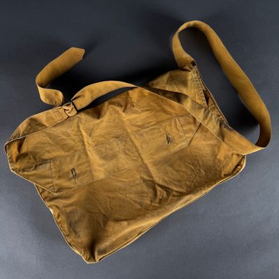 an old brown bag sitting on top of a black table