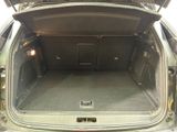 the back of a car with its trunk open and the door open