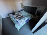 a bed that has a newspaper on it in a room