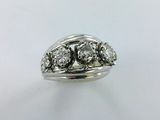 a close up of a ring with three diamonds on it