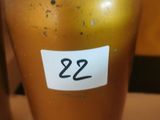 two brown vases with labels on them on a table