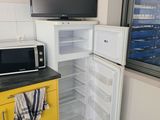a microwave and a microwave oven in the corner of a kitchen