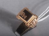 a gold ring with a black and white number on it