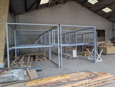 a large warehouse with a lot of wooden pallets in it