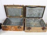 three old wooden boxes with metal handles are sitting on a table