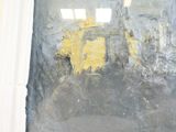 a painting on the wall of a building that has been painted yellow