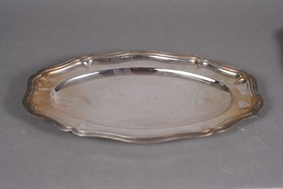 a silver tray on a table next to a remote control