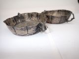 two silver dishes sitting on a white table