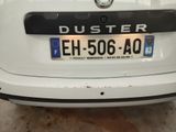 the rear end of a white car with a duster on it