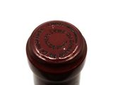 a close up of a bottle of wine on a white surface