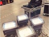 several lights are sitting on the floor in a warehouse