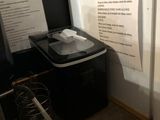 many papers on the wall next to a trash can