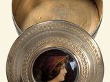 a silver box with a picture of a woman on it