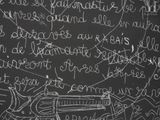 blackboard with a drawing of a gun and writing on it