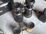 a table that has a bunch of old cameras on top of it