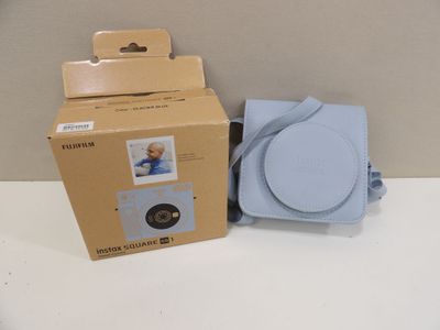 a box with a picture of a baby in it next to a camera