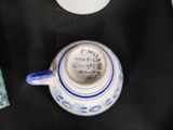 a blue and white cup sitting on top of a black table