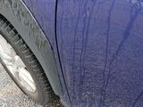 a close up of a car ' s tire on the road
